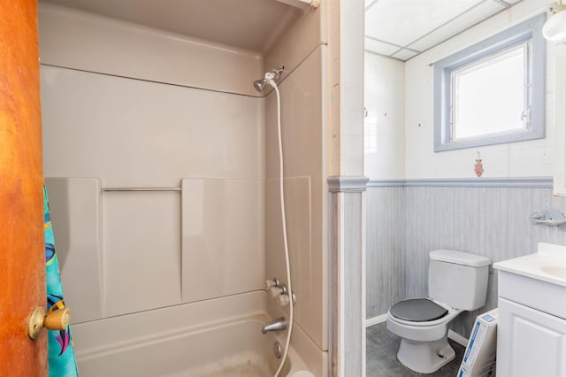 full bathroom featuring vanity, toilet, shower / washtub combination, and wooden walls