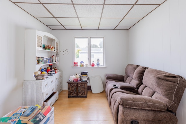 sitting room with light hardwood / wood-style flooring and a drop ceiling