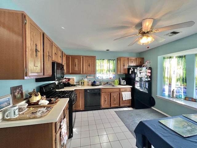 kitchen with light countertops, visible vents, black appliances, and light tile patterned flooring