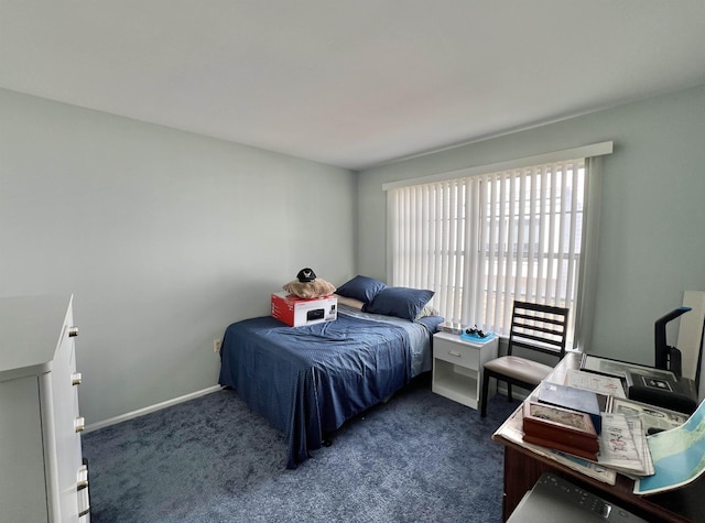 bedroom featuring carpet flooring and baseboards