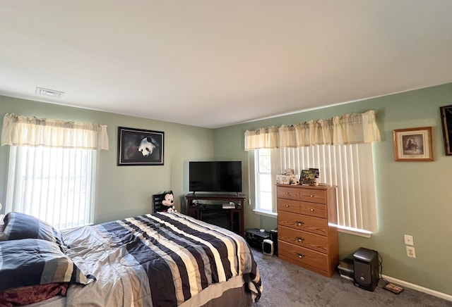 carpeted bedroom with visible vents and baseboards