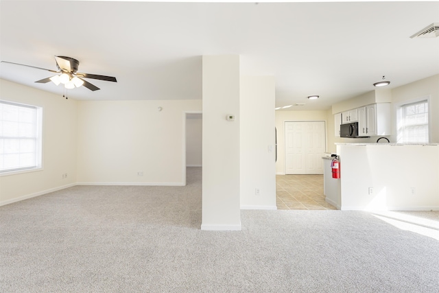 carpeted empty room featuring ceiling fan