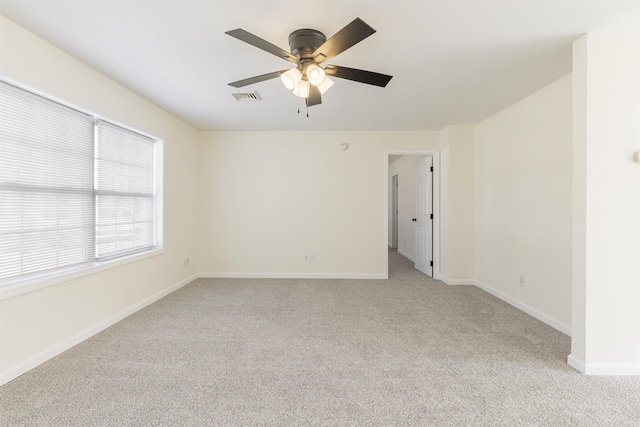 spare room with light carpet and ceiling fan