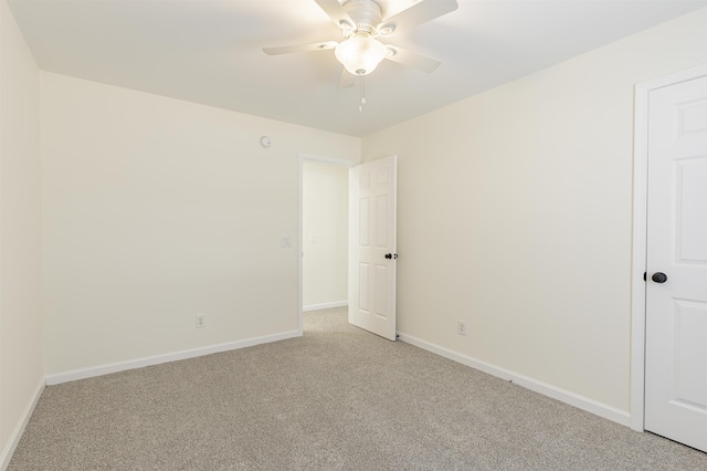 carpeted empty room featuring ceiling fan