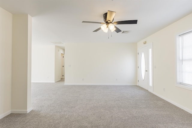 empty room with ceiling fan and light colored carpet