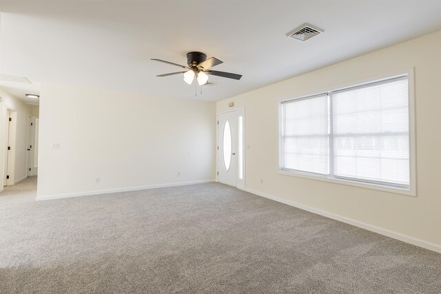 empty room featuring light carpet and ceiling fan