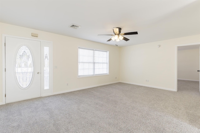 carpeted foyer entrance featuring ceiling fan