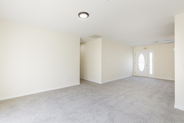 unfurnished living room featuring light carpet