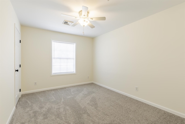 carpeted spare room featuring ceiling fan