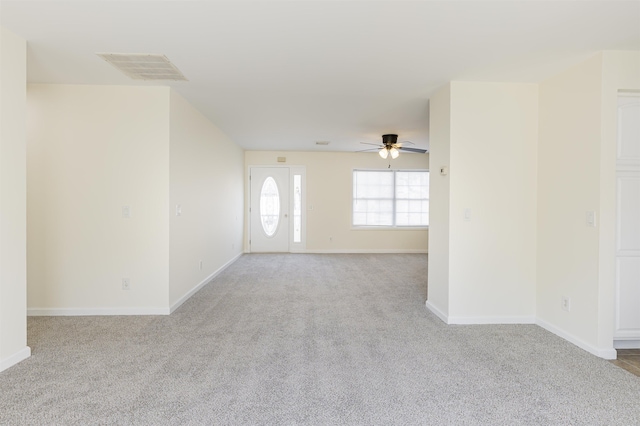 carpeted spare room featuring ceiling fan