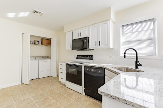 kitchen featuring sink, white cabinetry, black appliances, light stone countertops, and light tile patterned flooring