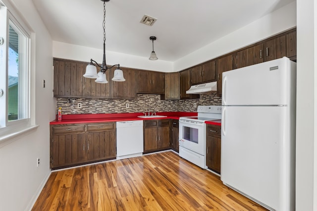 1 Cypress Ct, Rio Grande, NJ 08242 - kitchen with white appliances, under cabinet range hood, a sink, a chandelier, and backsplash
