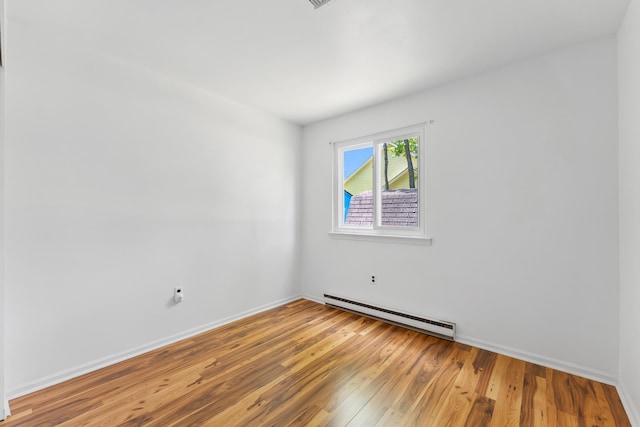 1 Cypress Ct, Rio Grande, NJ 08242 - empty room featuring a baseboard radiator, wood finished floors, and baseboards