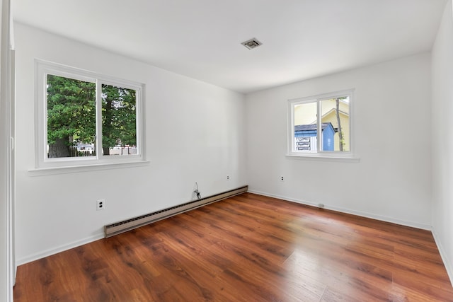 1 Cypress Ct, Rio Grande, NJ 08242 - unfurnished room with a baseboard heating unit, plenty of natural light, wood finished floors, and baseboards