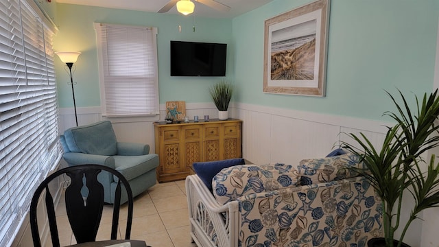 living area featuring ceiling fan and light tile patterned flooring