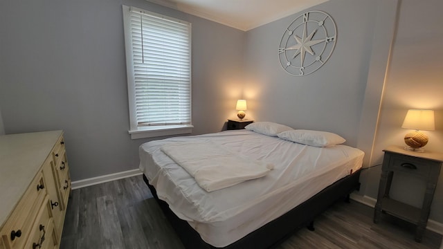 bedroom featuring ornamental molding and dark wood-type flooring