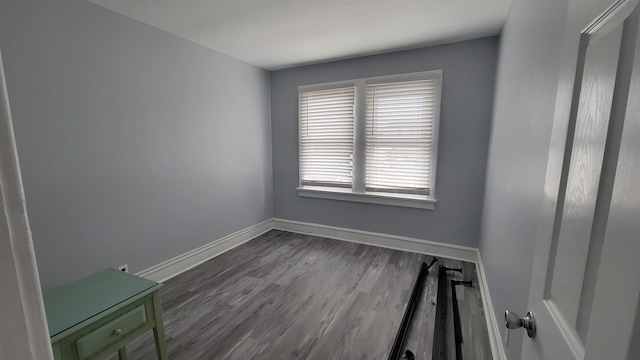 spare room featuring dark wood-type flooring