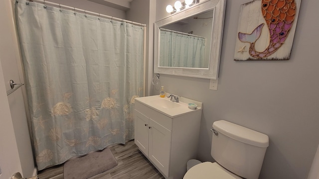 bathroom featuring hardwood / wood-style flooring, vanity, toilet, and a shower with shower curtain