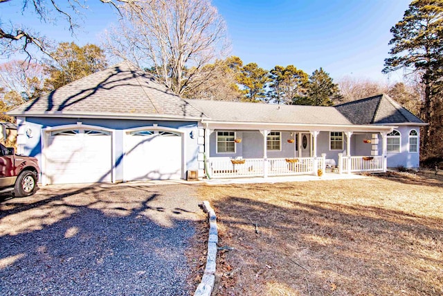 ranch-style house featuring a garage and covered porch