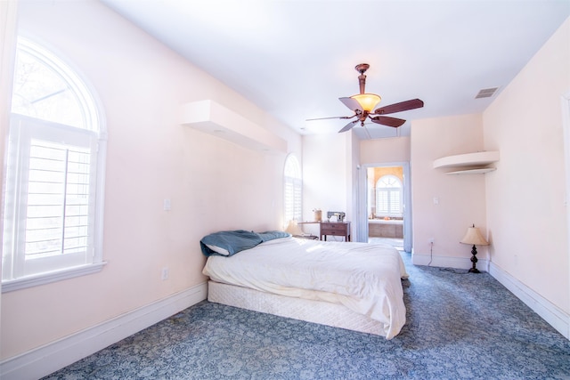 bedroom featuring ceiling fan and dark carpet