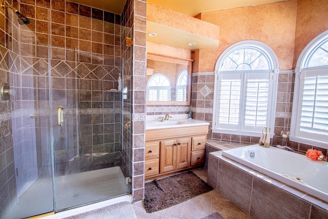 bathroom featuring vanity, a wealth of natural light, and tile walls