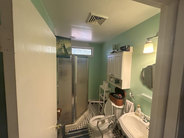 bathroom featuring a stall shower, visible vents, a sink, and toilet