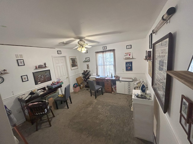 office with dark colored carpet and a ceiling fan