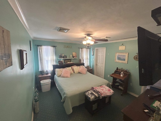 carpeted bedroom featuring baseboards, ornamental molding, visible vents, and a ceiling fan