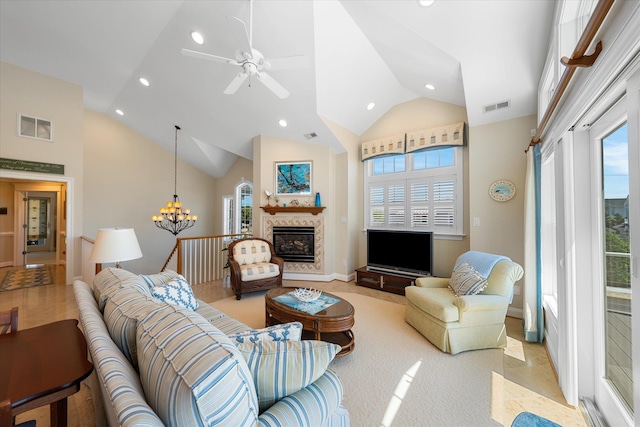 living room featuring ceiling fan with notable chandelier and high vaulted ceiling