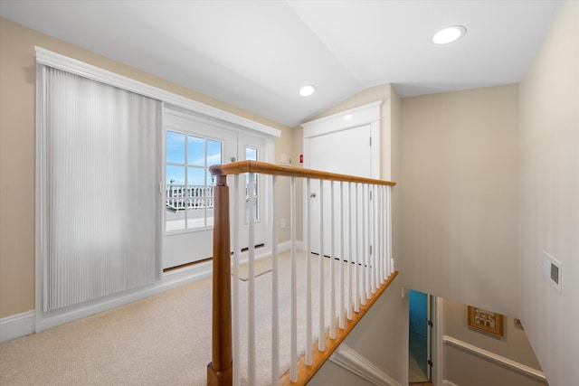 corridor featuring carpet floors and lofted ceiling