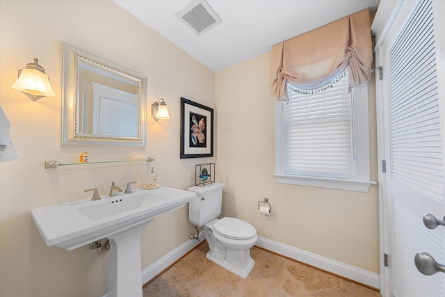 bathroom featuring tile patterned floors and toilet