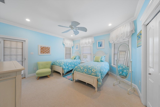 carpeted bedroom featuring ceiling fan, a closet, and ornamental molding