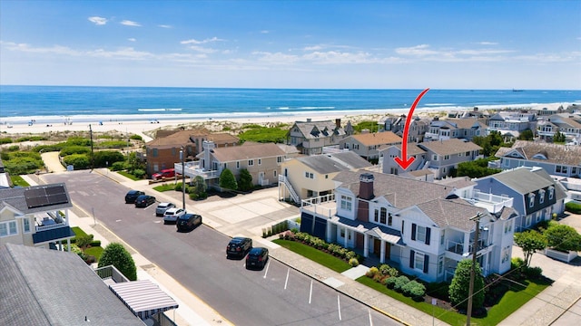 aerial view featuring a water view and a beach view