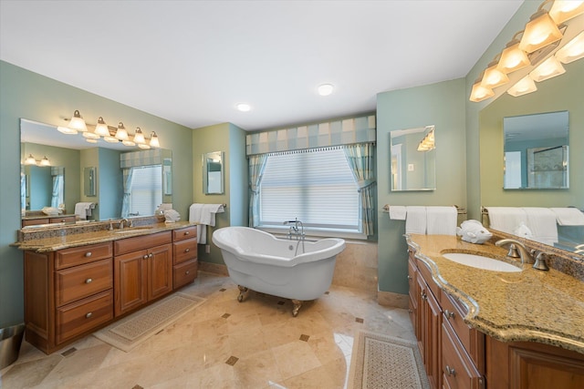 bathroom with a tub to relax in, tile patterned floors, and vanity