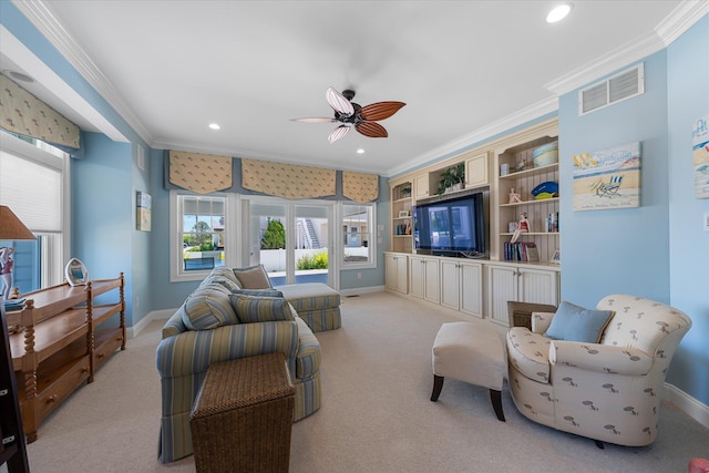 carpeted living room featuring ceiling fan and ornamental molding