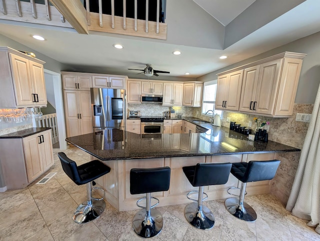 6 Pierces Point Rd, Cape May Court House, NJ 08210 - kitchen featuring appliances with stainless steel finishes, a peninsula, recessed lighting, backsplash, and a breakfast bar area