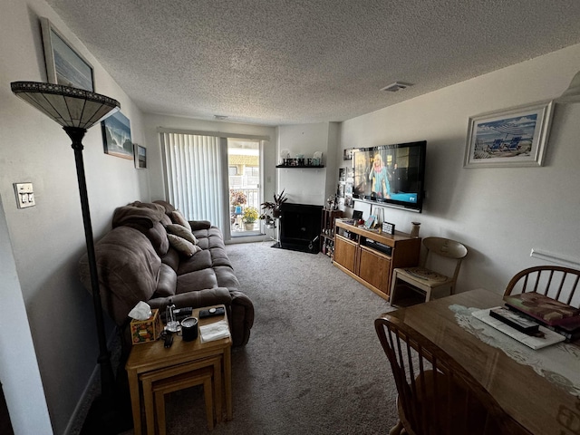 carpeted living room featuring a textured ceiling