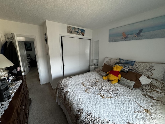 carpeted bedroom featuring a textured ceiling and a closet