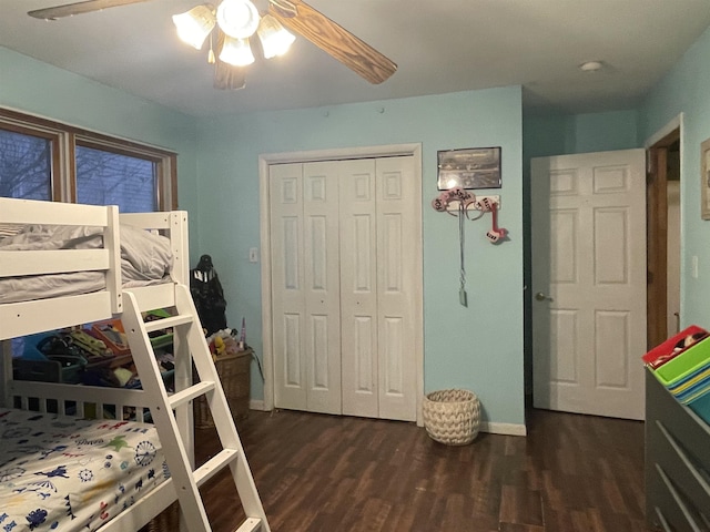 bedroom featuring ceiling fan, dark hardwood / wood-style flooring, and a closet