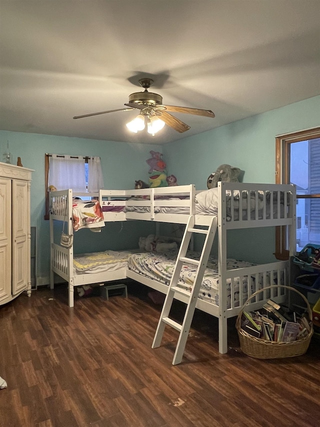 bedroom with ceiling fan and dark wood-type flooring