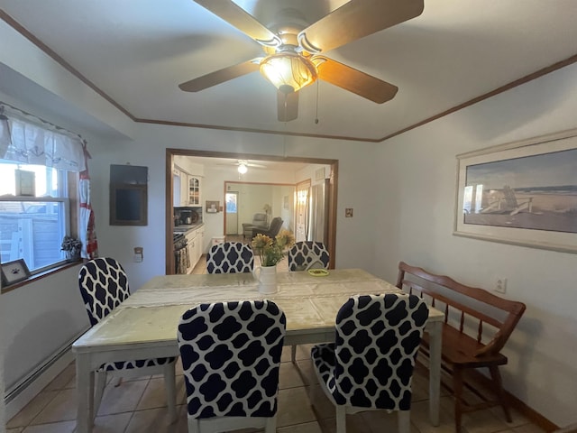 dining room featuring tile patterned floors, ceiling fan, crown molding, and baseboard heating