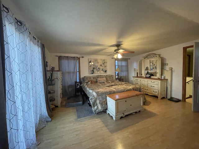 bedroom with ceiling fan and light hardwood / wood-style floors