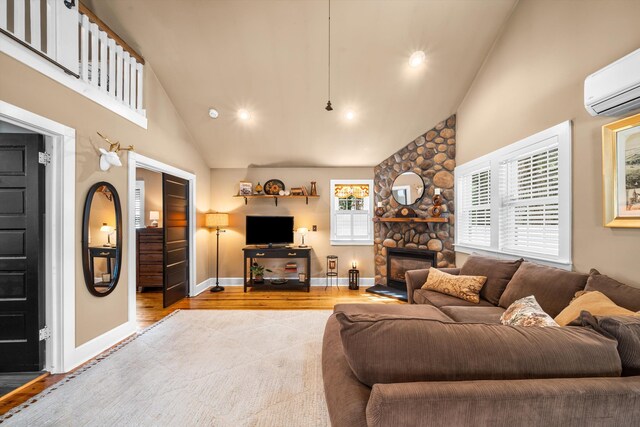 2068 N Shore Rd, Clermont, NJ 08210 - living room with high vaulted ceiling, a wall unit AC, a fireplace, wood finished floors, and recessed lighting