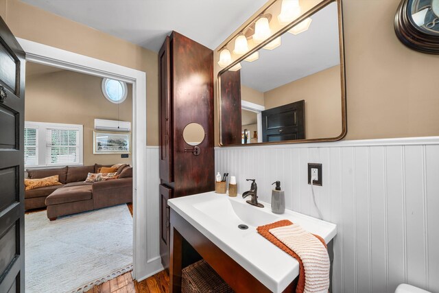 2068 N Shore Rd, Clermont, NJ 08210 - bathroom featuring a wainscoted wall, wood finished floors, a wall mounted air conditioner, and vanity