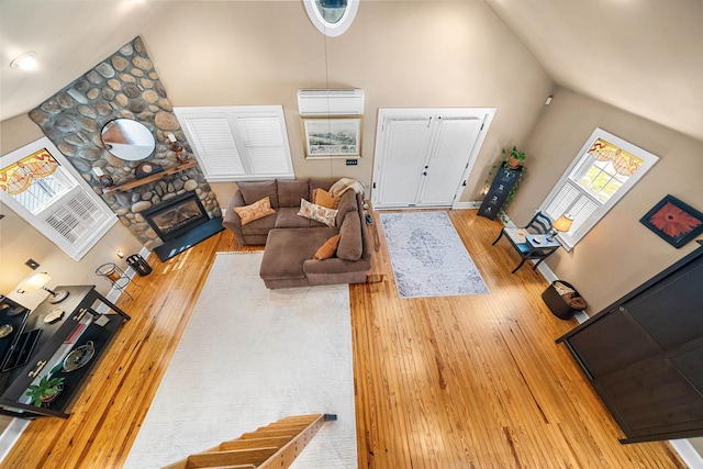2068 N Shore Rd, Clermont, NJ 08210 - living room with high vaulted ceiling, wood-type flooring, an AC wall unit, and a fireplace