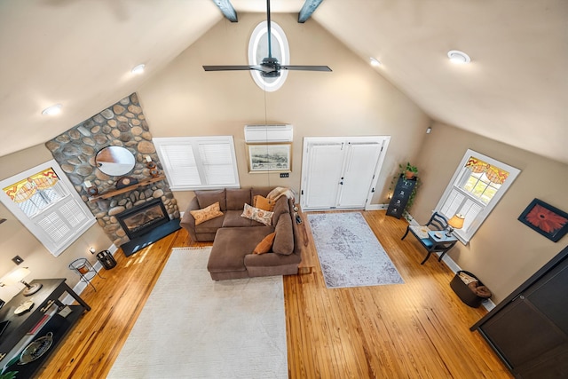 2068 N Shore Rd, Clermont, NJ 08210 - living room featuring high vaulted ceiling, wood finished floors, ceiling fan, a fireplace, and a wall mounted AC