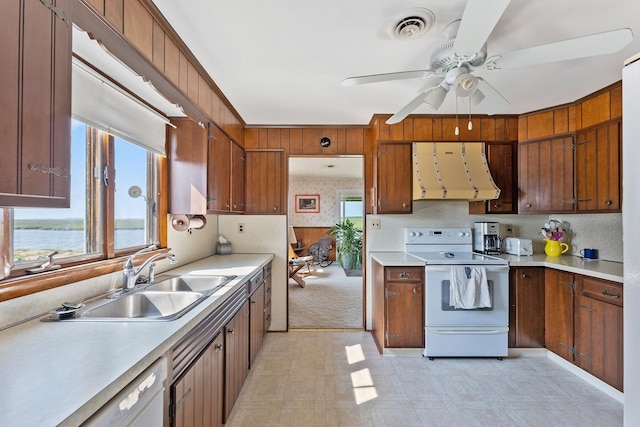 kitchen with ceiling fan, sink, ventilation hood, white appliances, and a water view