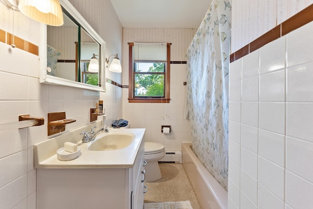 full bathroom featuring vanity, toilet, tile walls, a baseboard radiator, and shower / tub combo