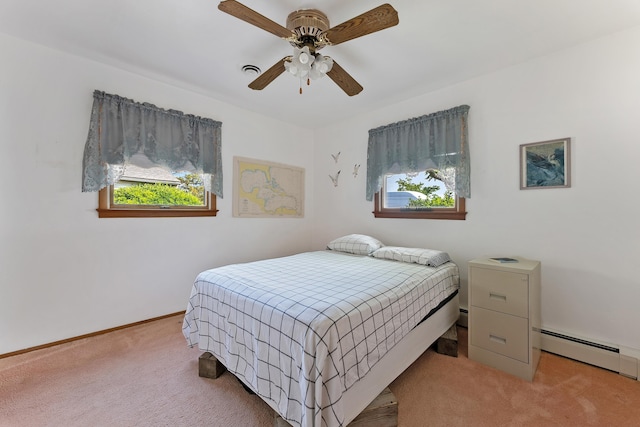 bedroom with light carpet, baseboard heating, and ceiling fan