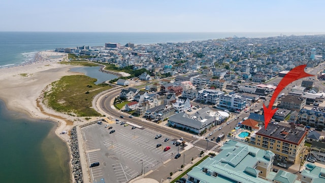 aerial view with a water view and a beach view